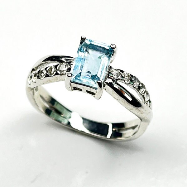 Silver aquamarine ring with rectangular cut gemstone and sparkling zircon details