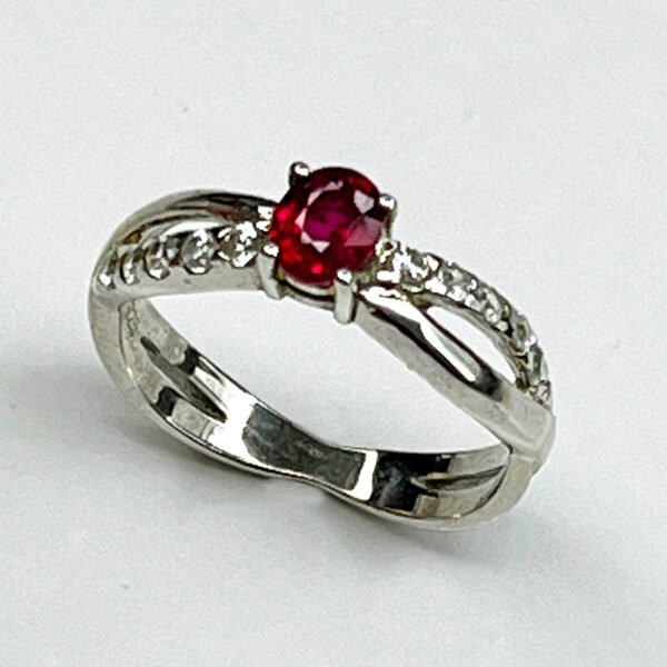 Elegant silver ring featuring a natural ruby with white zircon accents