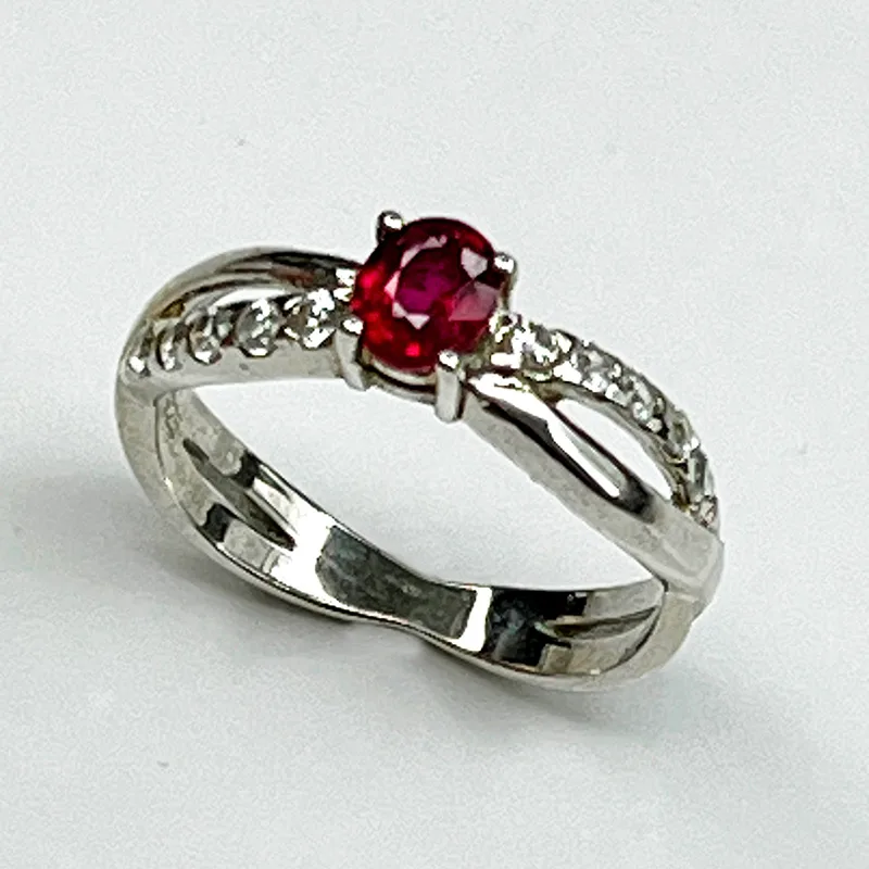 Elegant silver ring featuring a natural ruby with white zircon accents