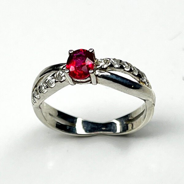 Elegant silver ring featuring a natural ruby with white zircon accents