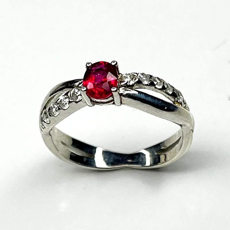 Elegant silver ring featuring a natural ruby with white zircon accents