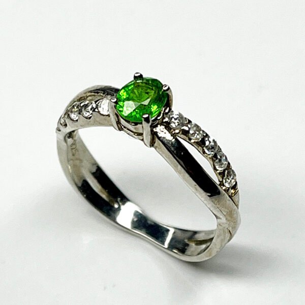 Silver ring featuring a vivid tsavorite garnet and white zircon accents